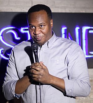 Roy Wood Jr. holding a microphone.