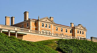 A three-story beige Renaissance Revival mansion