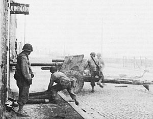US Army artillerymen firing a 3-inch Gun at German Defenses in Saint Malo during August 1944