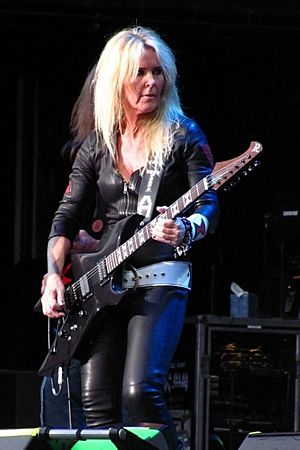 Lita Ford playing a guitar onstage
