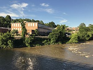 The renovated Saxapahaw Spinning Mill building along the Haw River in the center of the village
