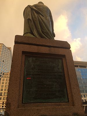 Sign of statue of robert milligan in canary wharf edited
