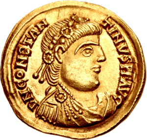 A gold coin showing the profile of a man wearing a wreath