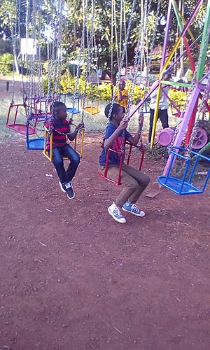African kids playing on swings