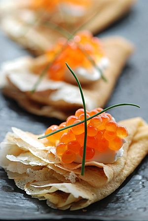Blini with sour cream and red caviar