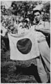 Lt. Woody J. Cochran holding a Japanese flag, New Guinea, 04-01-1943 - NARA - 519155