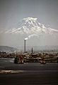 MT. RAINIER, WITH PORT OF TACOMA IN FOREGROUND. STACK BELCHING SMOKE MARKS THE KAISER ALUMINUM PLANT - NARA - 545243