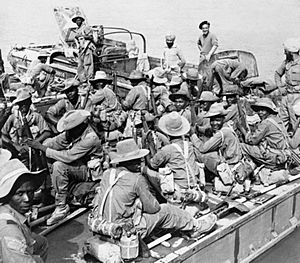 Soldiers of the 11th East African Division crossing the River Chindwin by ferry before moving towards the village of Shwegyin, Burma, December 1944. SE923