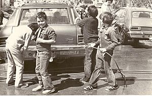 Group of cub scouts washing cars. Car in centre is a Chevrolet with a bumper sticker reading “Come join our world, fly with the Eagles”. (3778262600)