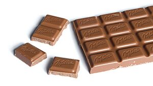 Milka Alpine Milk Chocolate bar 100g with chunks broken off