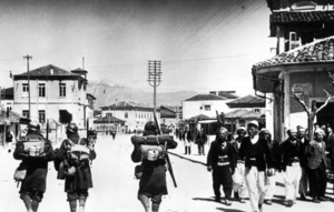 Italian soldiers passing Albanians, 7 April 1939