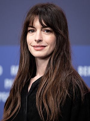 A head shot of Anne Hathaway as she smiles for the camera