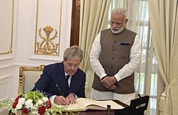 The Prime Minister of the Republic of Italy, Mr. Paolo Gentiloni signing the visitors’ book, at Hyderabad House, in New Delhi on October 30, 2017. The Prime Minister, Shri Narendra Modi is also seen