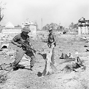 Troops of the West Yorkshire Regiment warily search Japanese dugouts in Meiktila, Burma, 28 February 1945. SE3287