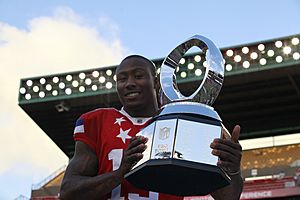 Miami Dolphins football team wide receiver Brandon Marshall receives the National Football League's 2012 Pro Bowl Most Valuable Player trophy at Aloha Stadium in Honolulu Jan 120129-M-DX861-231