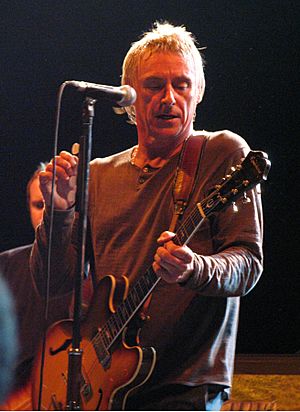 Weller playing guitar