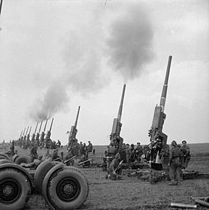 3.7-inch guns of 60th (City of London) Heavy Anti-Aircraft Regiment fire a salvo to celebrate the Allied victory in Europe