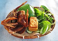 Fried pigeon with nasi timbel (banana leaf wrapped rice), tempeh, tofu and vegetables, Sundanese cuisine, Indonesia