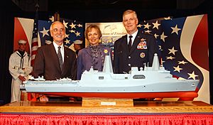 US Navy 040909-N-2568S-003 The Secretary of the Navy Gordon England, and the Chairman, Joint Chiefs of Staff Gen. Richard Myers, joined by his wife Mary Jo Myers, pose next to a model of a San Antonio-class amphibious dock land