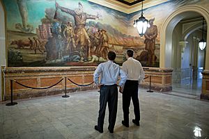 Kansas Governor Sam Brownback (left) and U.S. Secretary of Education --Arne Duncan observe a mural at the Kansas State Capitol in 2012