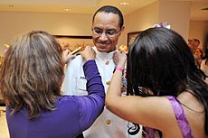 US Navy 120120-N-IT566-020 Adm. Cecil Haney has his new shoulder boards placed on his uniform by his wife and daughter