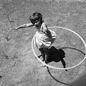 Girl twirling Hula Hoop, 1958