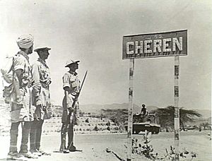 Indian troops stand next to a Cheren (Keren) signpost, May 1941.jpg