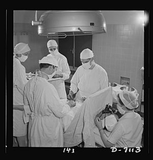 Young nurses assist at an appendectomy 8b07788v
