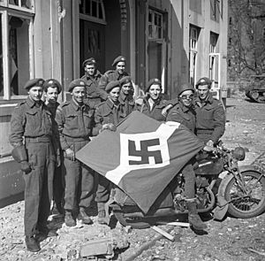 Captured German flag, Friesoythe, Germany, 16 April 1945.jpg