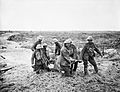 A team of stretcher bearers struggle through deep mud to carry a wounded man to safety near Boesinghe on 1 August 1917 during the Third Battle of Ypres. Q5935