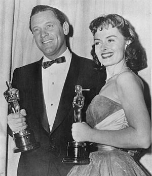 William Holden and Donna Reed hold their gold-plated Oscars, 1954