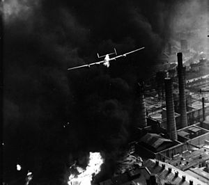 "The Sandman", a B-24 Liberator, emerging from smoke over the Astra Română refinery, Ploiești, during Operation "Tidal Wave" (1 August 1943)