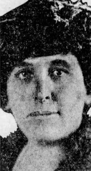 A newspaper photo of a white woman wearing a dark hat and a fur stole
