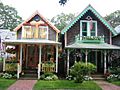 Two gingerbread cottages; both feature weathered cedar shingling and brightly colored trim elements.