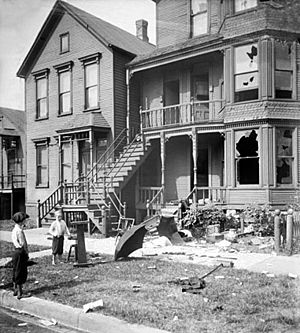 Chicago race riot, house with broken windows and debris in front yard