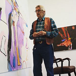 Rick Bartow with his paintings at Froelick Gallery, Portland, Oregon.jpg
