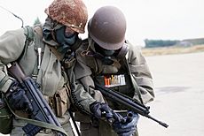Norwegian soldiers w respirators and radio