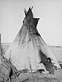 Oglala girl in front of a tipi2