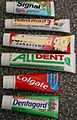 A photo of 6 tubes of toothpaste where each tube is a unique brand