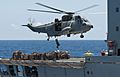 Flickr - Official U.S. Navy Imagery - A helicopter lowers a crew member.