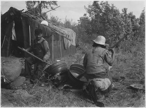 Paul Buffalo and wife parching wild rice at their camp - NARA - 285212