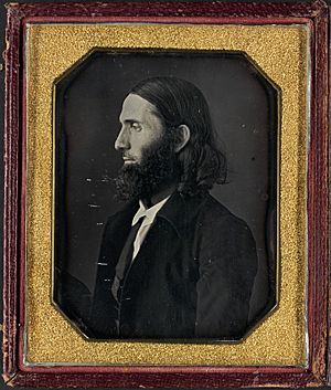 side-facing portrait of Burleigh a man with long hair and a long chin bears