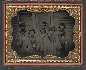 Five unidentified prisoners of war in Confederate uniforms in front of their barracks at Camp Douglas Prison, Chicago, Illinois LCCN2012646159