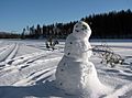 Snowman on frozen lake