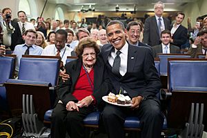 President Barack Obama presents cupcakes with a candle to Hearst White House columnist Helen Thomas in honor of her birthday in the James Brady Briefing Room