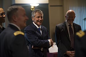 Secretary of Defense Chuck Hagel, center, shares a laugh with other guests before a retirement ceremony for U.S. Army Gen. Keith B. Alexander March 28, 2014, at the National Security Agency (NSA) at Fort George 140328-D-EV637-372