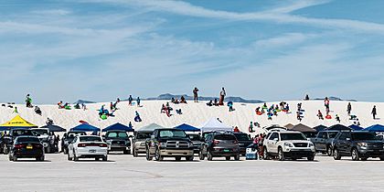 Visitors sledding and picnicking at White Sands National Park, New Mexico, United States
