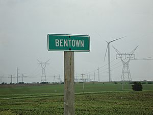 Town sign with turbines in background