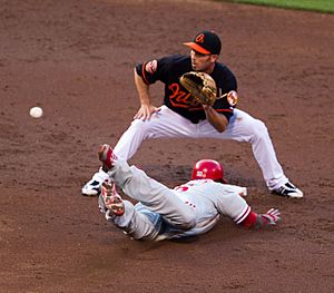 John Mayberry, Jr. steals second base; JJ Hardy seeks to catch the throw-cropped