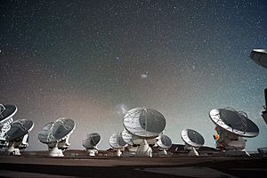 The Atacama Large Millimeter submillimeter Array (ALMA) by night under the Magellanic Clouds